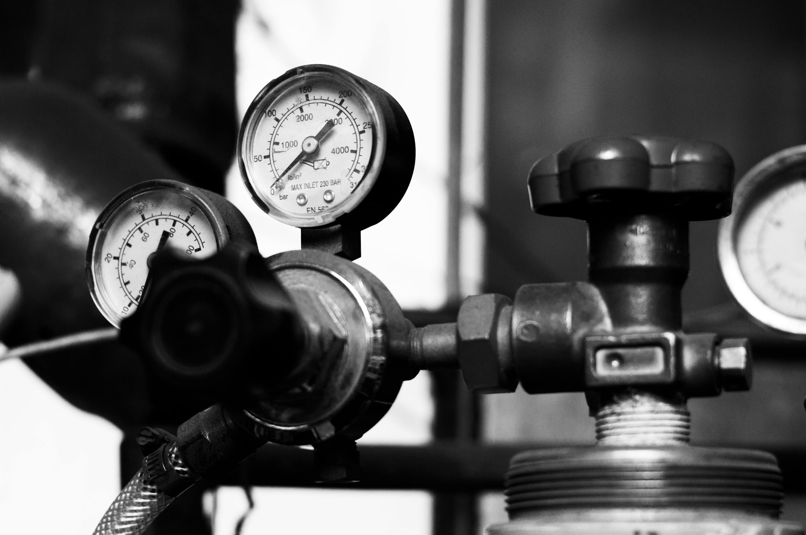pexels photo 16679540 16679540 Black and white close-up of vintage pressure gauges and industrial metal machinery.