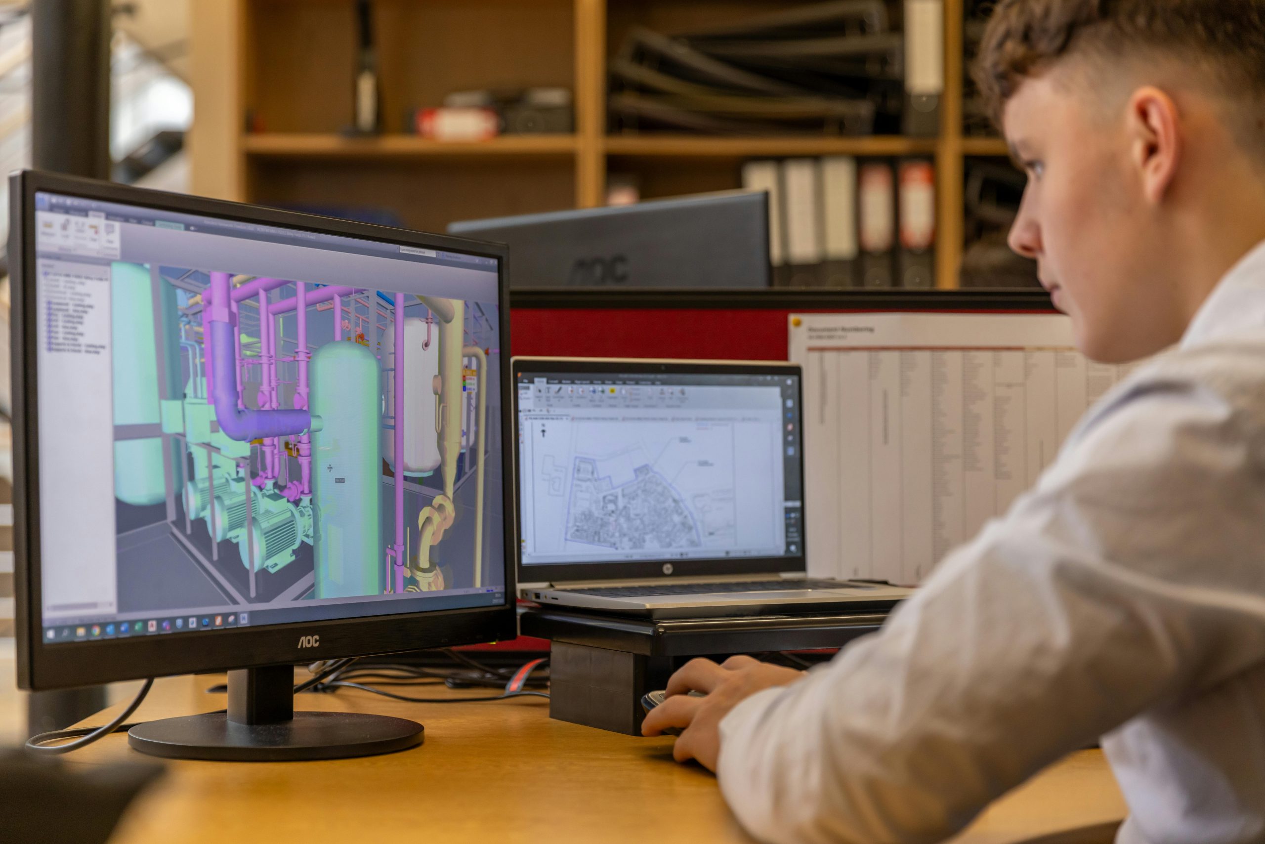 pexels photo 19895882 19895882 Engineer working with CAD software on dual monitors in an office setting.