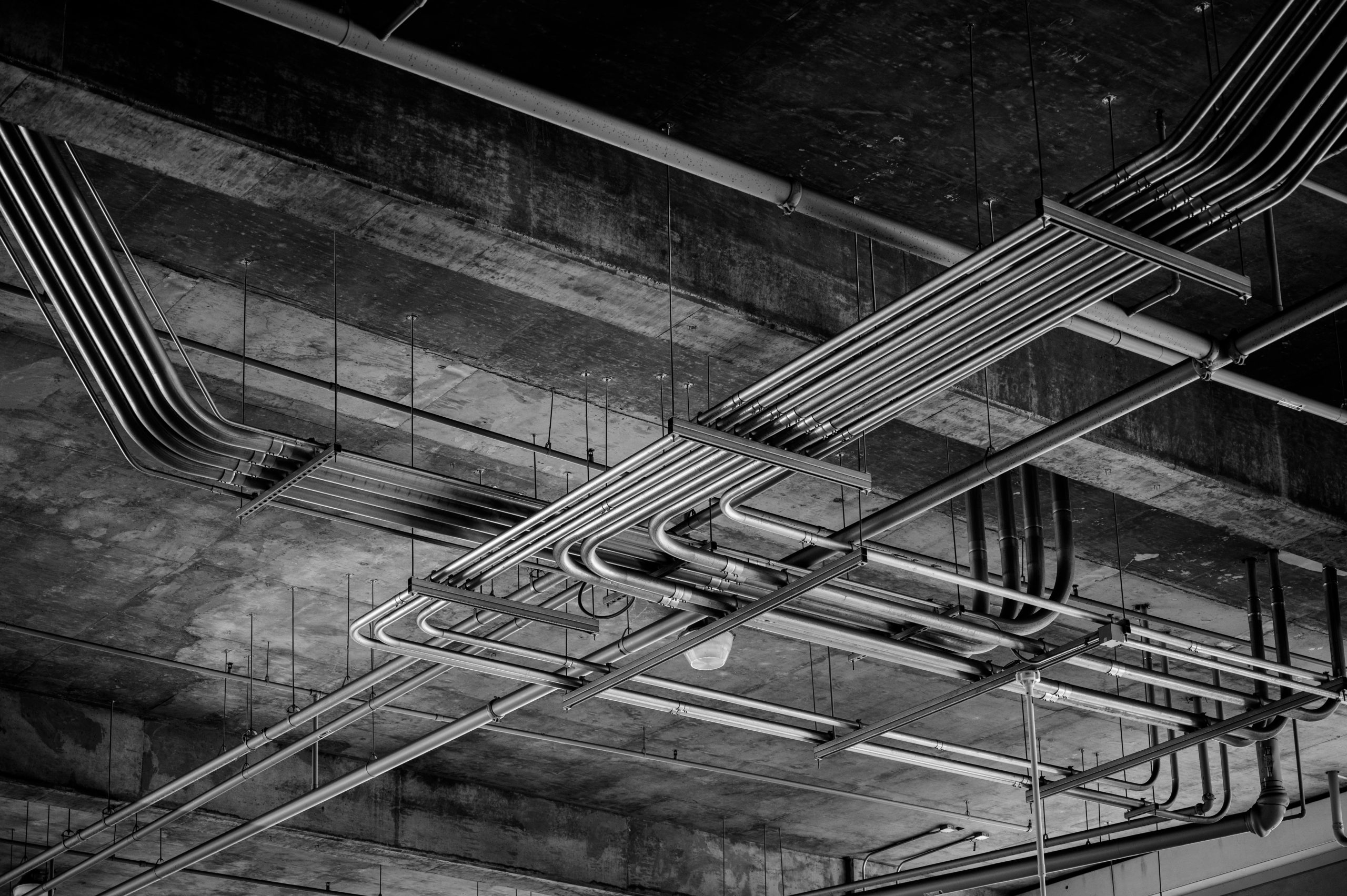 Black and white photo of industrial ceiling with metal pipelines in Boise, ID.
